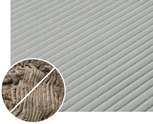 Gray corduroy fabric with distinct diagonal ribs and a soft, textured surface.